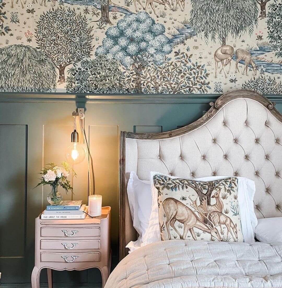 Decorative bedroom with tufted headboard, Edwardian wall panelling, patterned wallpaper, and nightstand.